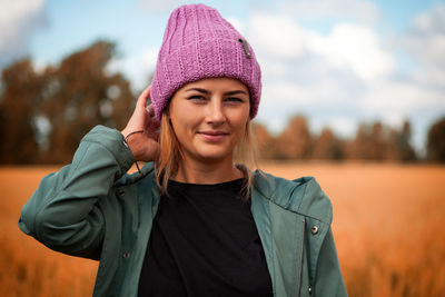 Portrait female student on field background. beautiful modern young woman 