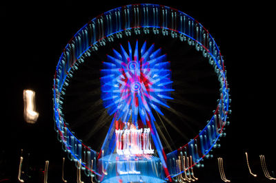 Low angle view of illuminated ferris wheel