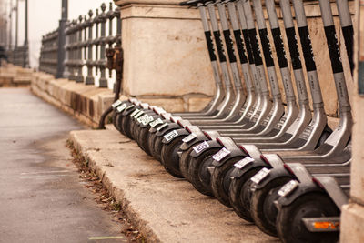 Scooters stand in a row on the street, scooter rental