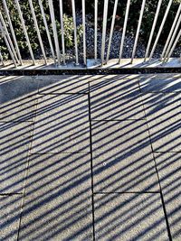 Shadow of railing on footpath