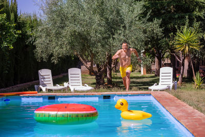 Rear view of woman swimming in pool