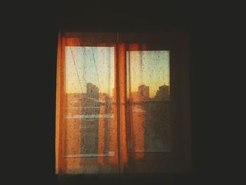 Window with curtain in darkroom at home