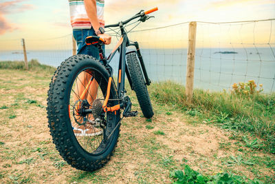 Fat bike on the beach with guy holding it