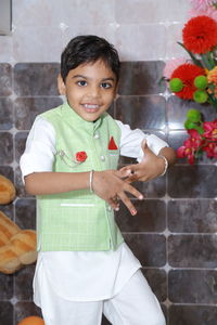 Portrait of cute girl standing on footpath