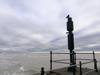 View of sculpture at beach against sky