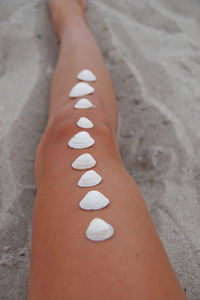 Low section of woman on sand