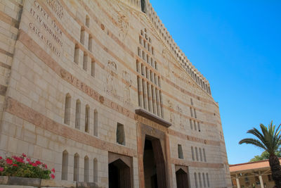 Low angle view of building against clear blue sky