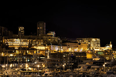 High angle view of illuminated buildings against sky at night