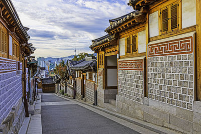 Street amidst buildings against sky