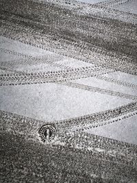 Close-up of tire tracks on sand