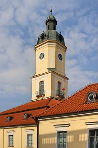 The tower and the roof of the historic town hall building in bialystok. red roof, clock tower 