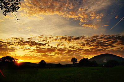 Silhouette landscape against sky during sunset