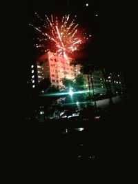 Low angle view of firework display at night