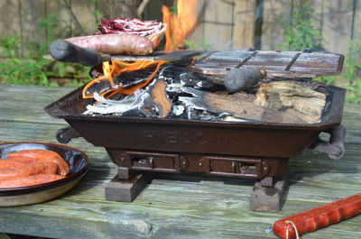 Close-up of sausage and purple cabbage being grilled on barbecue