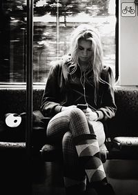 Full length of woman sitting on bench