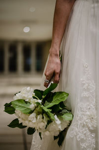 Close-up of cropped hand holding flower