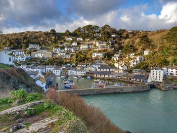 Panoramic shot of townscape by sea against sky