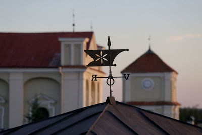 Close-up of weather vane against sky