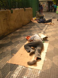 Man sitting on footpath