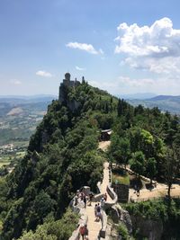 People on mountain against sky