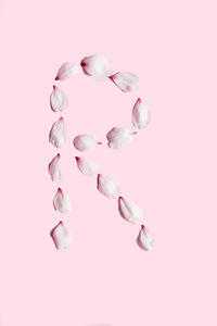 Close-up of pills over pink background