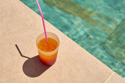 High angle view of drink on table at swimming pool