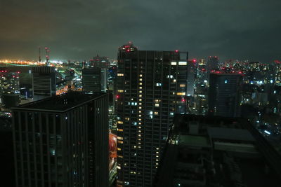 High angle view of illuminated buildings in city at night