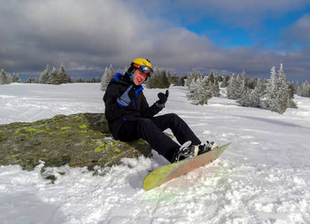 Man on snowy mountain against sky