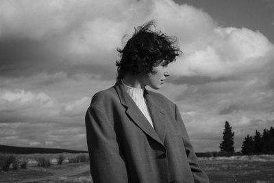 Full length of woman standing on field against sky