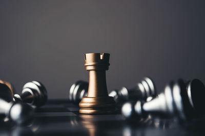 Close-up of chess pieces against gray background