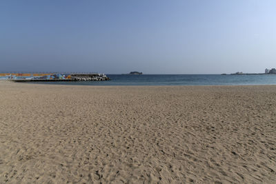 Scenic view of beach against clear sky
