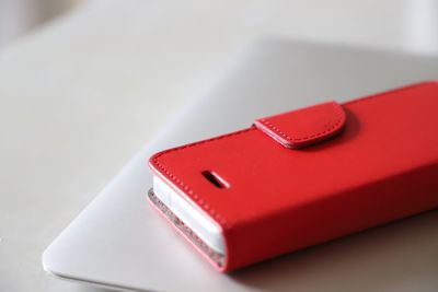 Close-up of mobile phone on laptop