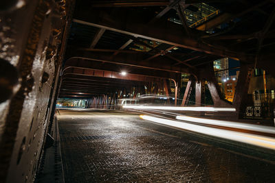 Illuminated light trails on road in city at night