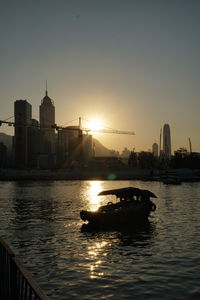 View of boats in river against buildings