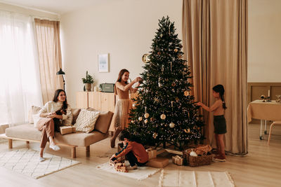 Family lifestyle. mom and kids are preparing for the christmas holidays in decorated house in winter