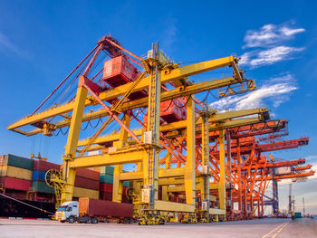 Low angle view of crane against sky