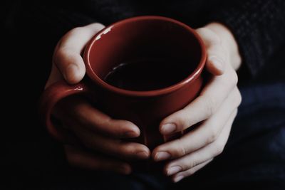 Close-up of hand holding black tea