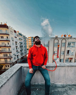 Rear view of man standing against building