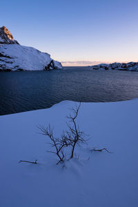 Scenic view of lake against clear sky during winter