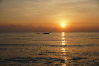 Scenic view of sea against orange sky