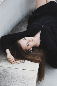 Portrait of woman lying down on floor