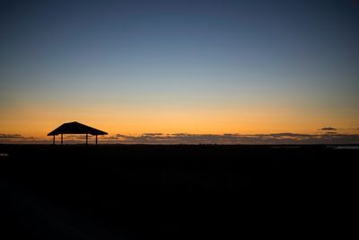 Scenic view of beach against sky during sunset