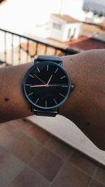 Close-up of hand holding clock