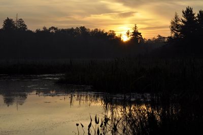 Scenic view of lake against sky during sunset