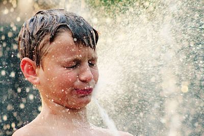 Close-up of boy playing in water