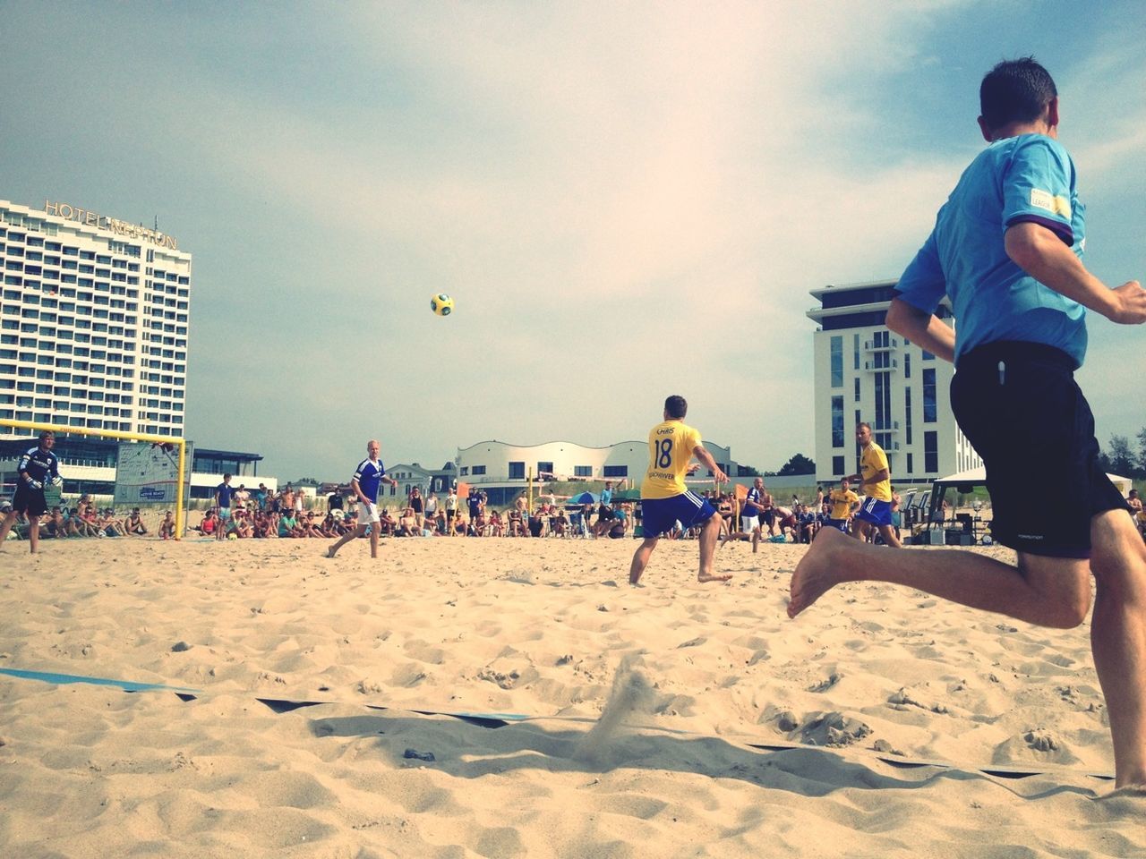 beach, lifestyles, leisure activity, sand, sky, men, shore, cloud - sky, person, building exterior, built structure, vacations, sea, walking, standing, architecture, water, day