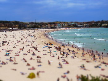 People on beach against sky