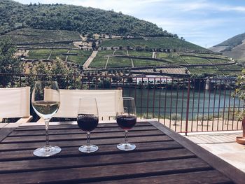 Tables and chairs on table against mountains