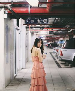 Full length portrait of woman standing in city