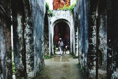 Rear view of people walking outside building